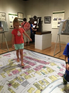 girl walking through exhibit